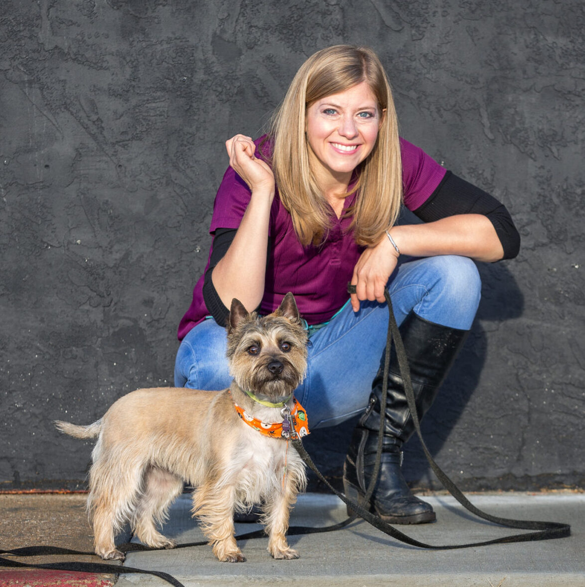 emily coleman lead trainer canine solution poses with dog